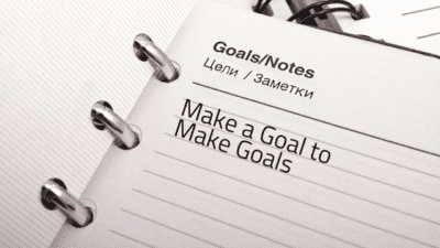 a spiral bound notebook with the words make a goal to make goals written on it