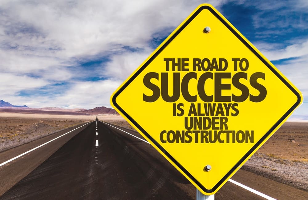 a road sign that says the road to success is always under construction
