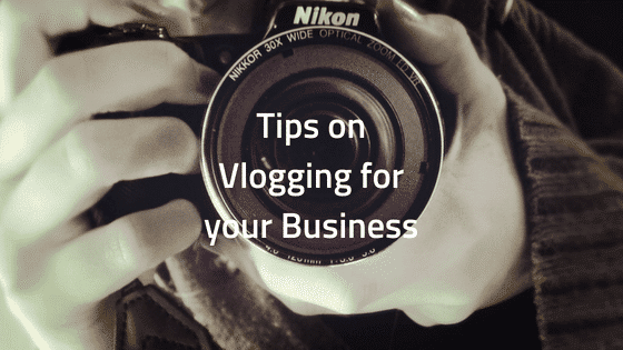 a person holding a camera with the words tips on vlogging for your business