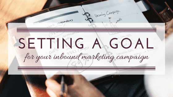 a person writing on a piece of paper with the words setting a goal for your inbound marketing campaign