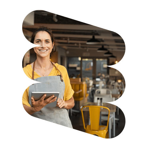 a woman in an apron holding a tablet