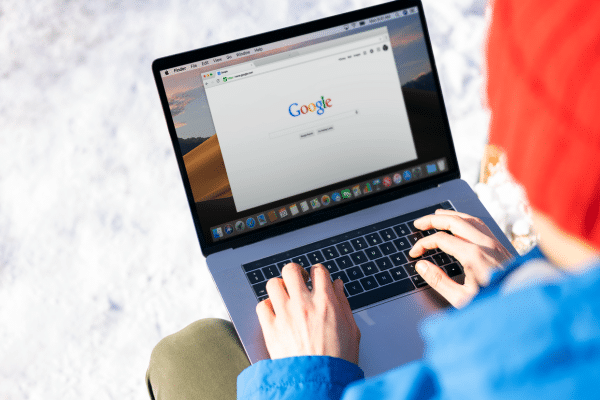 a person using a laptop computer in the snow