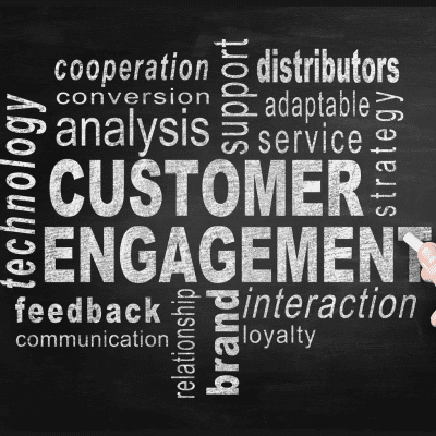 a hand writing customer engagement on a blackboard