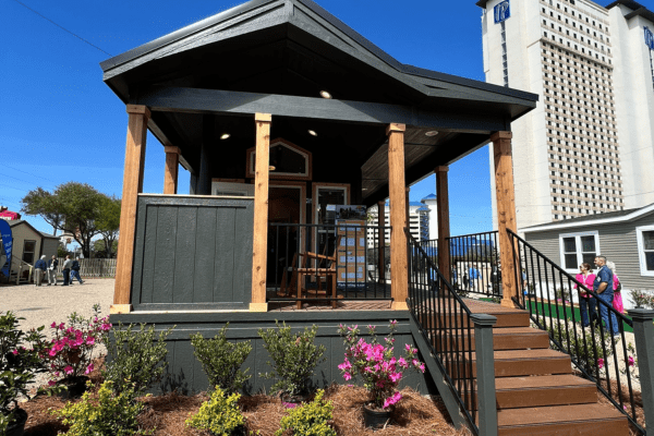 a gazebo sitting next to a building with a clock tower in the background