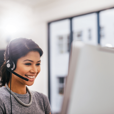 a woman wearing a headset and using a computer