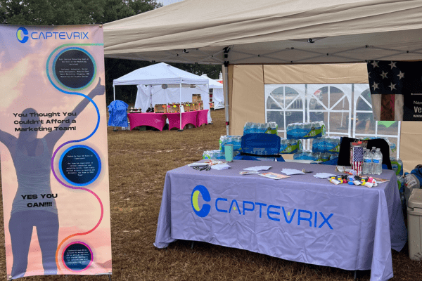 a tent set up with a table and a sign