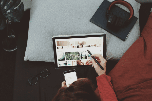 a person sitting on a couch using a laptop computer