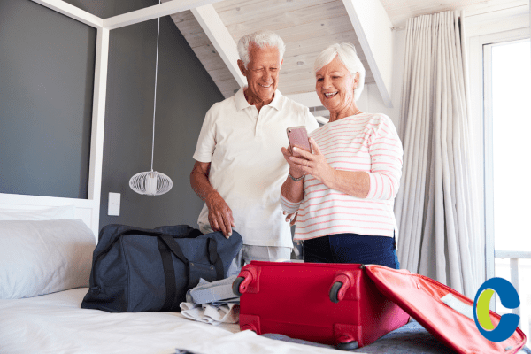 a man and woman standing next to a bed