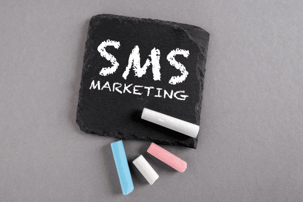 a slate with the words sms marketing written on it